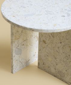 a white marble table sitting on top of a floor