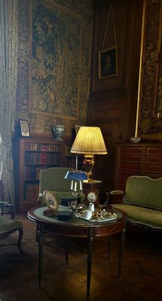 a living room filled with furniture and a lamp on top of a coffee table in front of a window