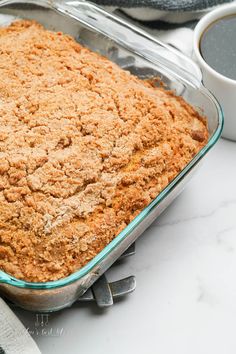 an easy eggless coffee cake in a glass baking pan on a marble countertop