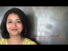 a woman is smiling in front of a gray and white background with the words, i am