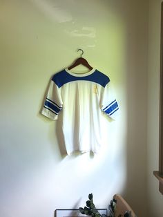 Up for sale is a vintage 1960's to 1970's Dodgers Sportswear "Lakers" athletic style shirt with beautiful graphics on the front and sleeves. Overall the garment is in good condition with no major rips or tears. There are some various faded spots of discoloration though no egregious stains exist (see photos for noted flaws). Dodger Sportswear 50% cotton 50% polyester Tag size: M Estimated size: S to M Measured flat (inches across): Length (back bottom of collar to bottom hem): 23 1/2 Pit to pit: Affordable Vintage T-shirts For Sports Season, Womens Vintage Workout Shirt, Retro College T-shirt With Screen Print, White Collegiate T-shirt With Three Stripes, Retro Sports Crew Neck Top, Retro Sports Tops With Crew Neck, Retro Crew Neck Sports Top, Collegiate Crew Neck Top With Three Stripes, College Cotton T-shirt With Three Stripes