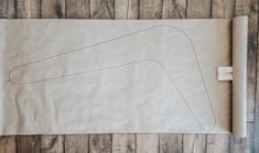 a piece of paper with a drawing on it sitting on top of a wooden floor