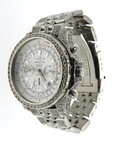 Introducing the fully iced-out real diamond Breitling Bentley 48mm watch. This luxurious watch is the perfect combination of style and sophistication. The stainless steel bezel, case, and band are all adorned with real diamonds for a truly opulent look. The dial is a crisp white color, and the hands are white as well. The markers are black and in a stick style, and the crystal is a scratch-resistant sapphire coating. The watch is powered by an automatic movement and is secured with a deployant c Formal Diamond Watches With Bling, Luxury Watches With Bling And Cubic Zirconia, Luxury Watches With Cubic Zirconia Bling, Diamond Bling Watches For Anniversary, Luxury Watches With Rhinestones, Luxury Formal Watches With Rhinestones, Luxury Watches With Rhinestones Round Dial, Luxury Diamond Watch With Rhinestones, White Gold Diamond Watch With Rhinestones