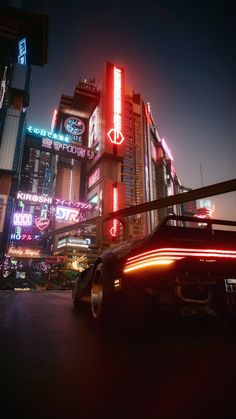 a futuristic city at night with neon signs on the buildings and cars driving down the street