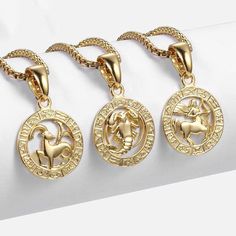 three gold necklaces with horses on them