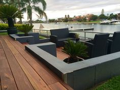 an outdoor seating area on a deck overlooking the water