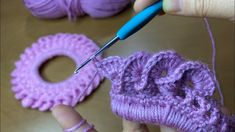 someone is crocheting the yarn on top of an object with a knitting needle