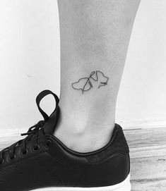 a black and white photo of a person's foot with a tattoo on it