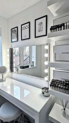 a room with a vanity, stools and mirror in the corner next to a window