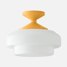 a yellow and white light fixture hanging from the ceiling