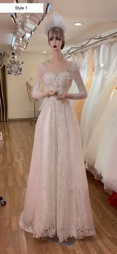 a mannequin wearing a pink dress and hat in a clothing store with dresses on display