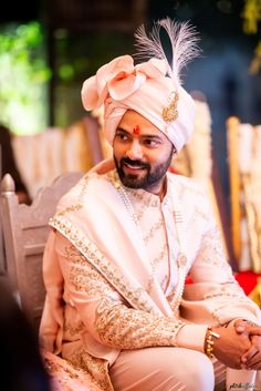 a man wearing a turban sitting on top of a chair