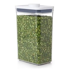 a glass container filled with green beans