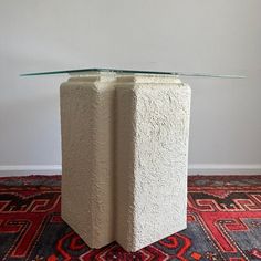 a glass table sitting on top of a rug