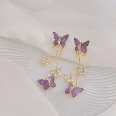 Description: Chic Butterfly Dangle EarringsSpecifications:Size: 5.5 cm * 1.4 cmWeight: 7 g/pairMaterial: Alloy, Bronze, Acrylic, Crystal, 14k goldColor: purple/blue Flutter your fashion flair with these Chic Butterfly Dangle Earrings! These playful earrings feature delicate butterfly dangles that add a touch of whimsy to any outfit. Perfect for expressing your unique style and adding a touch of fun to any look. Purple Butterfly Charm Jewelry For Party, Blue Butterfly Charm Dangle Earrings, Blue Dangle Earrings With Butterfly Charm, Purple Butterfly Charm Earrings For Gift, Purple Butterfly Earrings For Gift, Elegant Purple Butterfly Earrings, Trendy Purple Drop Earrings, Gold Butterfly Charm Earrings For Party, Party Earrings With Gold Butterfly Charm