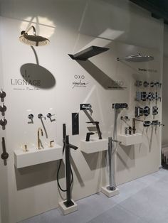 a store display with several different types of tools on the wall and below it are two sinks