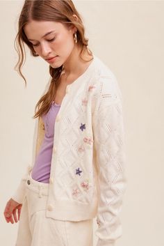 Upgrade your wardrobe with our Pop Floral Sweater Weaved Cardigan, featuring a unique design and high-quality materials that make it a valuable addition to any fashion-forward ensemble. With its intricate weaving and trendy pop floral pattern, this cardigan is sure to elevate your style and make a statement wherever you go. Made with care and attention to detail, it's a versatile piece that offers both warmth and a touch of elegance to complete your look. Details: features: • Pop floral with flo Cream Floral Embroidery Cardigan For Spring, Cream Floral Embroidered Cardigan For Spring, Casual Cream Cardigan With Floral Embroidery, Cream Pointelle Knit Spring Cardigan, Spring Pointelle Knit Long Sleeve Outerwear, Spring Long Sleeve Pointelle Knit Outerwear, White Cardigan With Button Closure For Spring, Floral Cardigan Outfit, Star Sweater