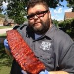 a man holding a large piece of meat in his hands