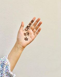 a woman's hand with a tattoo on it