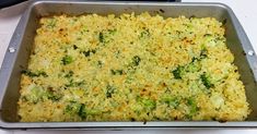 a casserole dish with broccoli and cheese in it on a table