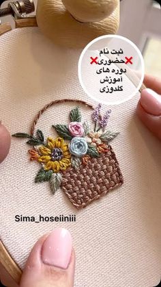 someone is stitching flowers in a basket