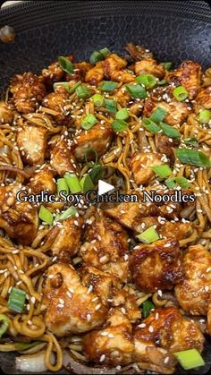 chicken and noodles with sesame seeds in a wok