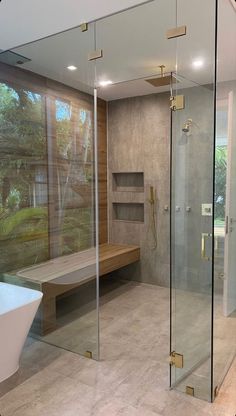 a bathroom with a large walk in shower next to a bathtub