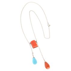 This necklace in 18-karat white gold is a triumph of color and sophistication, celebrating the unique beauty of natural gems in a contemporary design. At the center, an orange coral cut in a rectangular shape of approximately 14 mm dominates the composition with its vibrant and intense color, symbolizing energy and vitality. This piece of coral, carefully selected for its distinctive shape and warm hue, represents the pulsating heart of the jewel, drawing the gaze with its natural beauty. Flanking the central coral, two small diamonds add a touch of light and sophistication. Expertly placed, one on each side of the coral, these diamonds are chosen for their quality and glow, helping to create a visual balance and further enhancing the charm of the main stone. Harmoniously completing the de