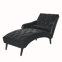 a black leather chaise lounge chair with wooden legs and foot rest on an isolated white background