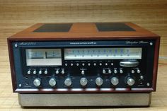 an old radio sitting on top of a wooden table