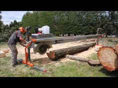 a man is using a chainsaw to cut logs