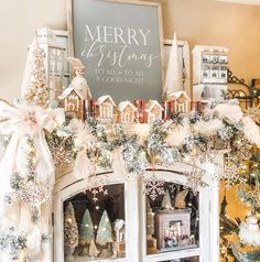 a christmas mantel decorated with white and silver decorations