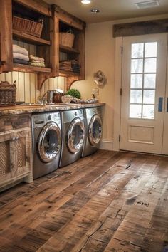 a washer and dryer in a room with wood flooring on the walls