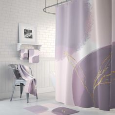 a bathroom with a shower curtain and rugs on the floor