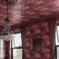 a chandelier hangs from the ceiling in front of a wallpapered room