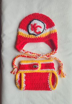 Kansas Cty Chiefs crocheted hat and diaper cover made with soft acrylic yarn. KC applique is all hand crocheted.  Diaper cover has adjustable button closure with 2 hidden buttons for added security. Smoke free and pet free home Crocheted Hat, Kc Chiefs, Baby Blanket Pattern, Gender Neutral Baby Clothes, Diaper Cover, Kansas City Chiefs, Blanket Pattern, Gender Neutral Baby, Baby Clothing