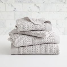 the west elm towels are stacked on top of each other