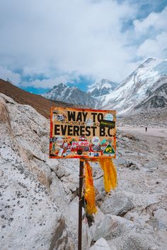 a sign that says way to everest bc in front of some snow covered mountains