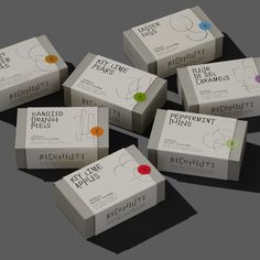 six boxes with different labels on them sitting next to each other in front of a gray background