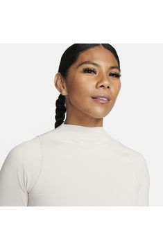 A snug fit and long sleeves with thumbhole cuffs add to the sporty vibe of this funnel-neck top made with the brand's Dri-FIT sweat-wicking technology. Funnel neck Long sleeves with thumbhole cuffs Dri-FIT moisture-wicking technology 80% nylon, 20% spandex Machine wash, dry flat Imported Functional Funnel Neck Stretch Top, Functional Stretch Tops With Funnel Neck, Athleisure High Neck Tops With Thumbholes, Functional Nike High Stretch Tops, Nike Functional High Stretch Tops, Nike Fitted Activewear For Fall, Sporty High Neck Tops With Thumbholes, Nike Fitted Winter Tops, Fitted Nike Tops For Winter