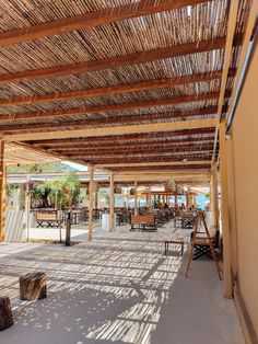 an outdoor covered area with tables and chairs