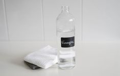 a bottle of water sitting on top of a table next to a white towel and cloth