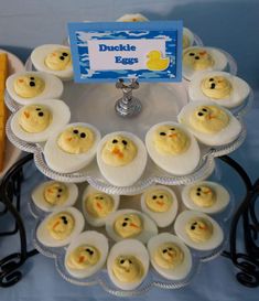 an assortment of deviled eggs are arranged on a cake plate