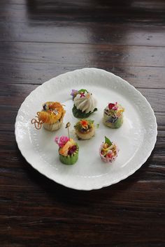 small appetizers are arranged on a white plate