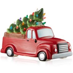 a red truck with christmas trees in the back