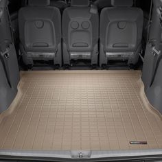 the interior of a vehicle with its trunk and floor mats folded down to show all four seats