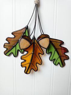 three stained glass leaves hanging from a hook