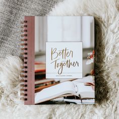 a book with the title'better together'is laying on a fluffy white blanket