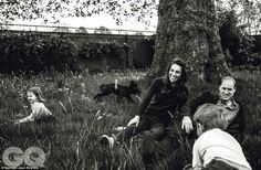 black and white photograph of people sitting in the grass