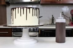 a cake sitting on top of a white counter next to a bottle of sprayer